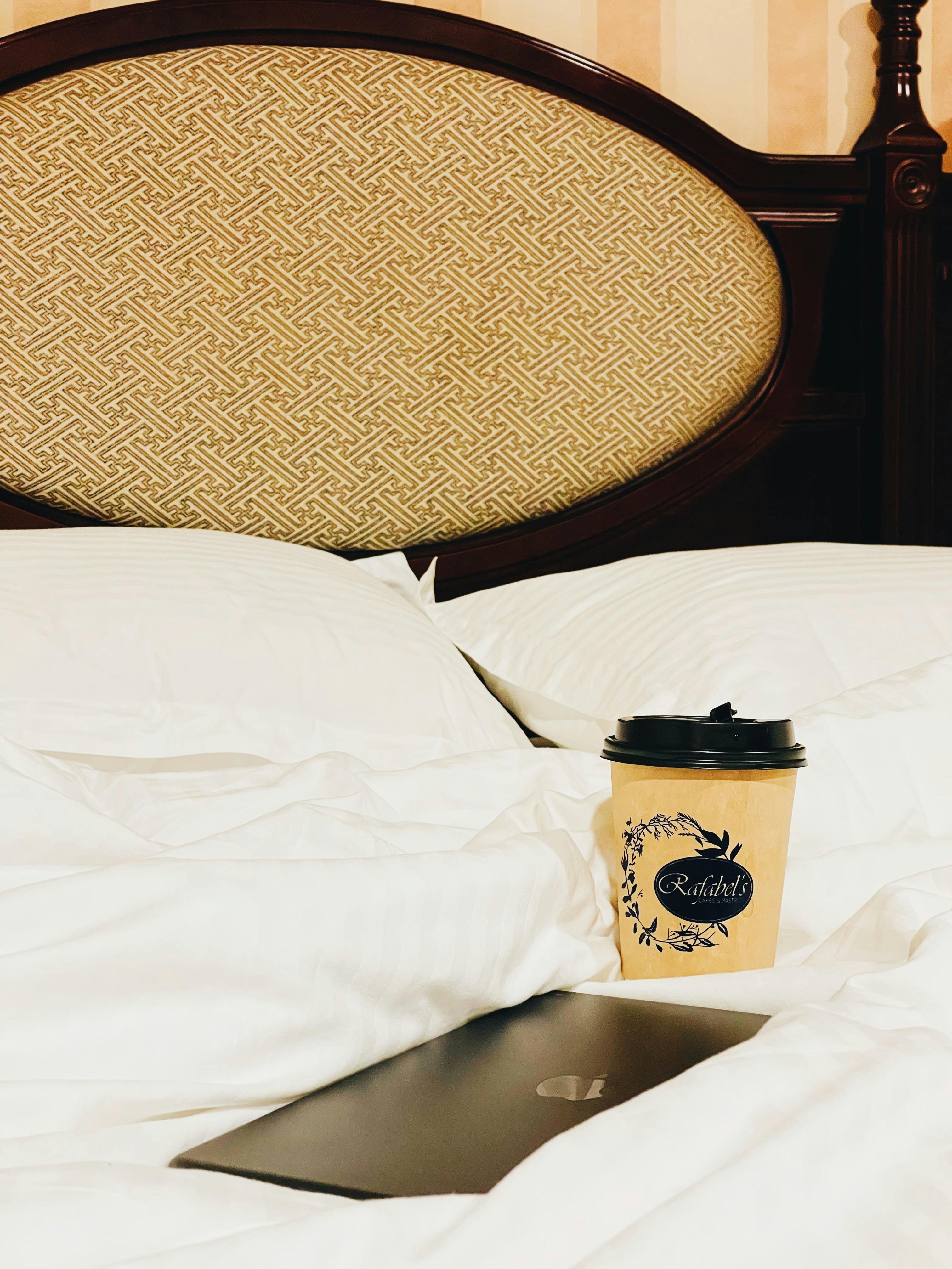 Brown Paper Cup with Lid on the Bed · Free Stock Photo