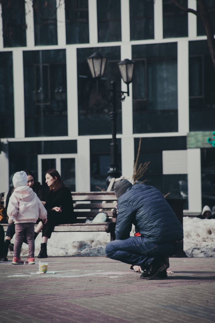 Busy People Wearing Winter Jacket On A Park