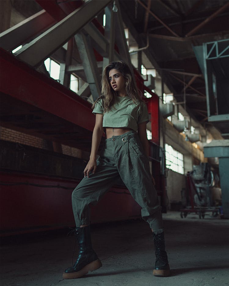 A Woman In Crop Top Shirt Standing Inside The Warehouse