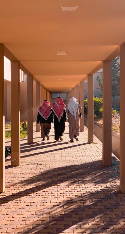 Back View of Walking Three Men in Keffiyeh