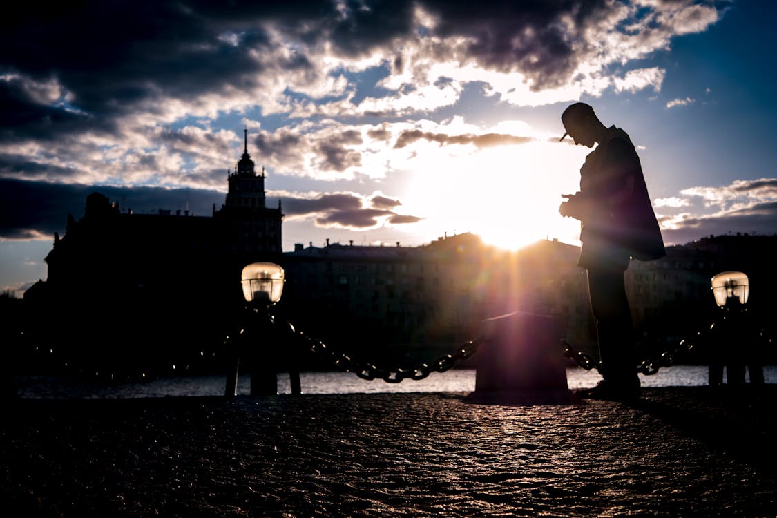 Silhouette of Man Near Body of Water