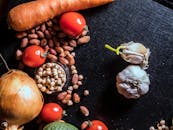 Variety of Spices and Vegetables on Black Surface