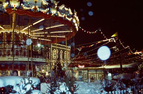 Free Illuminated carousel and festive lights at a winter carnival in Moscow's night scene. Stock Photo