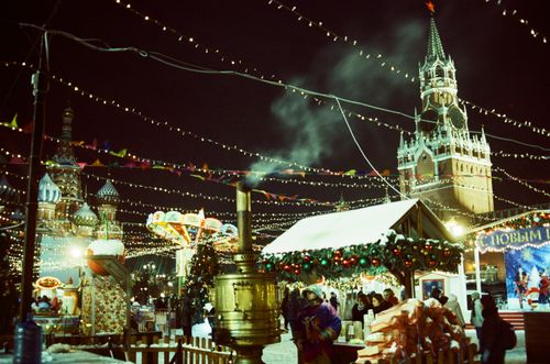 Free Colorful Christmas festival at Red Square, Moscow with Spasskaya Tower and holiday decorations. Stock Photo