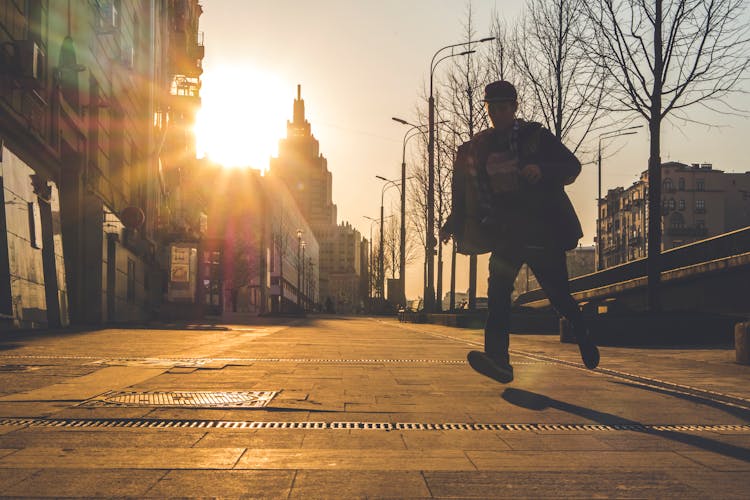 Man Running On Street During Sunset