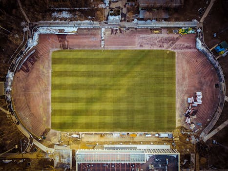Aerial photograph of an empty sports stadium with clear field and track.