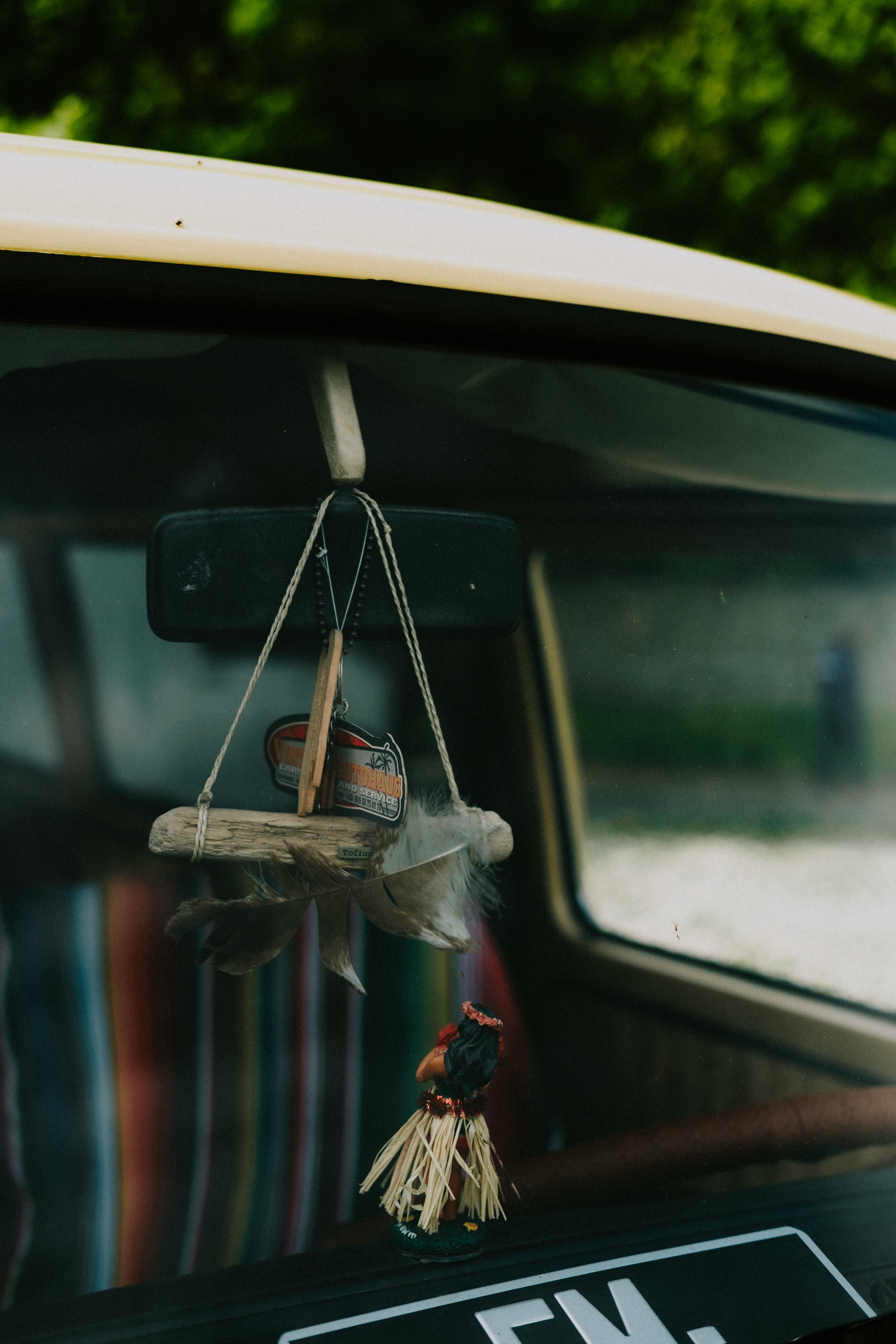 Wooden Decorations Hanging on Rearview Mirror · Free Stock Photo
