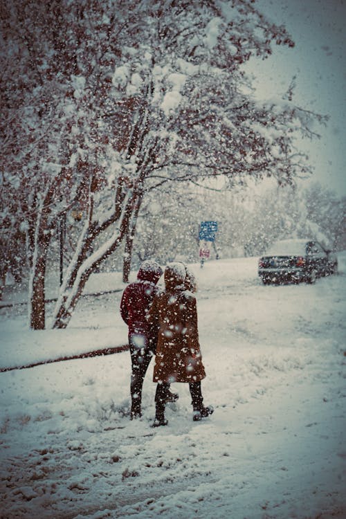 Couple Walking Together in a Snowy Road