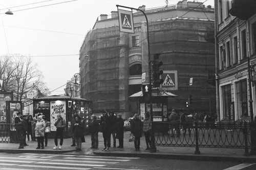 Free Black and white urban street photo with pedestrians and city architecture. Stock Photo