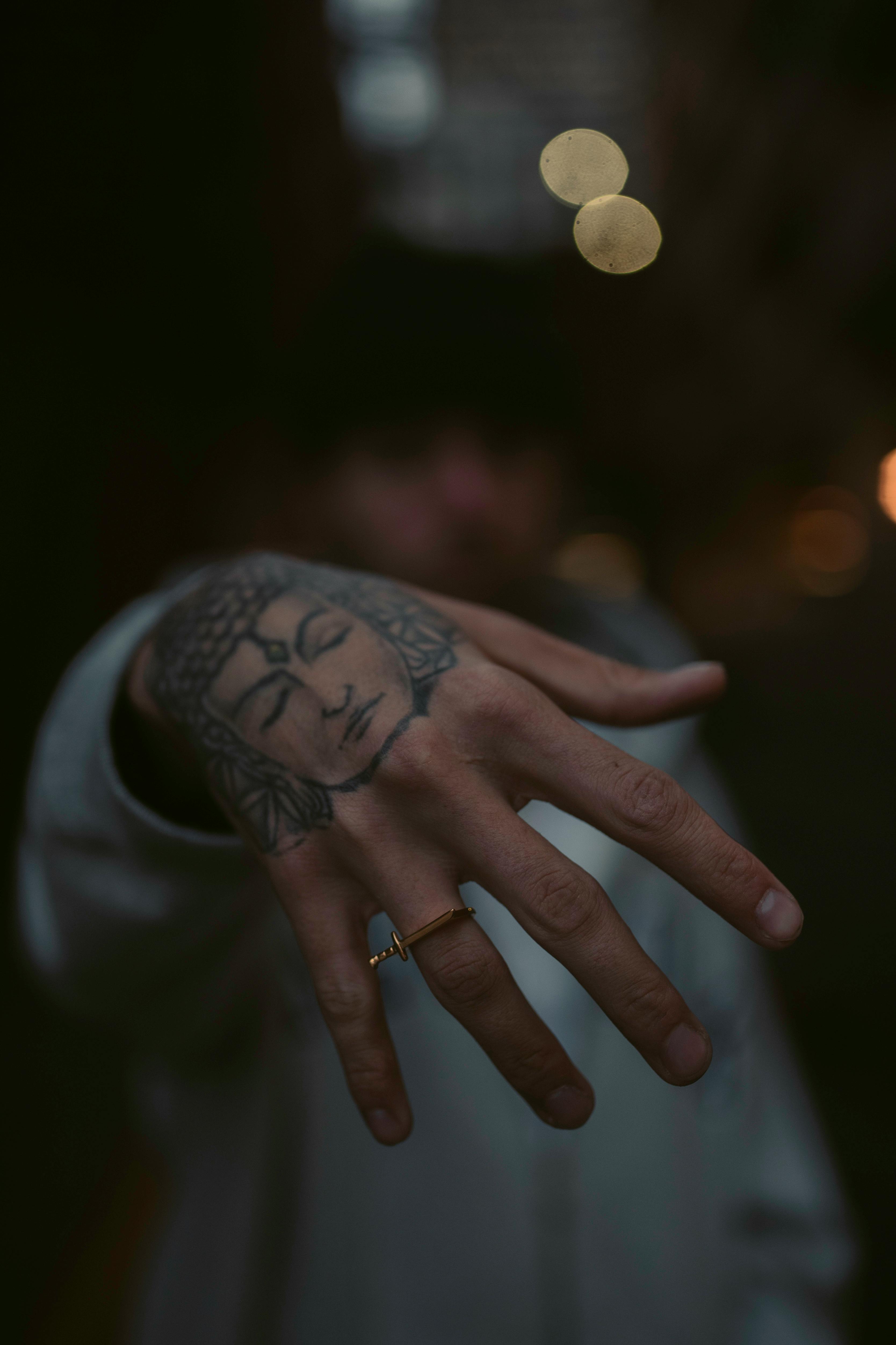 Boy's hand with Tattoos and rings fashion Stock Photo - Alamy