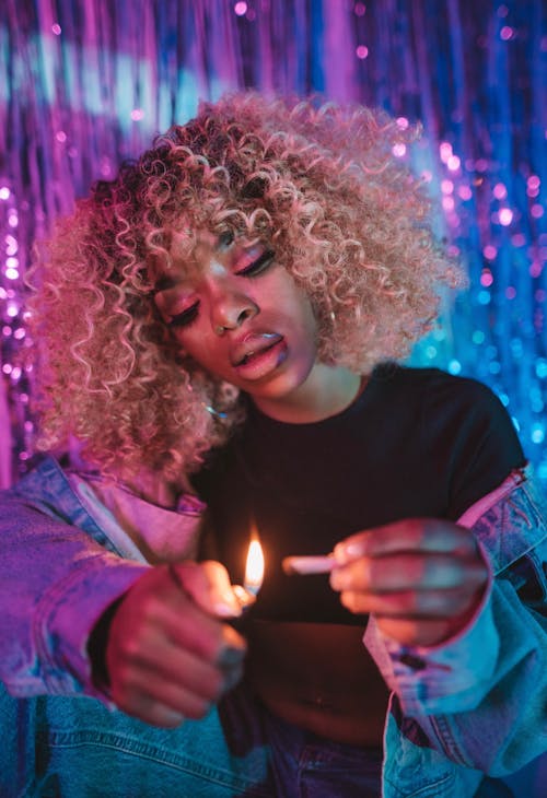 Portrait of a Woman Using a Lighter