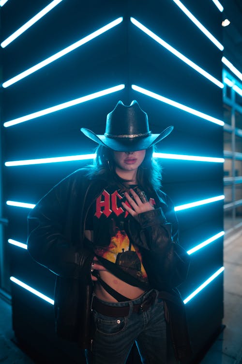 A Young Woman in a Jacket and Cowboy Hat