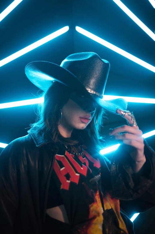 A Young Woman in a Black Leather Jacket and Cowboy Hat