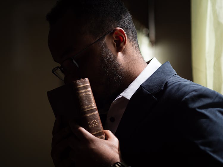 A Man Kissing The Holy Bible