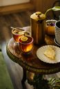 Tea with Lemon and Slice of Cake on a Plate