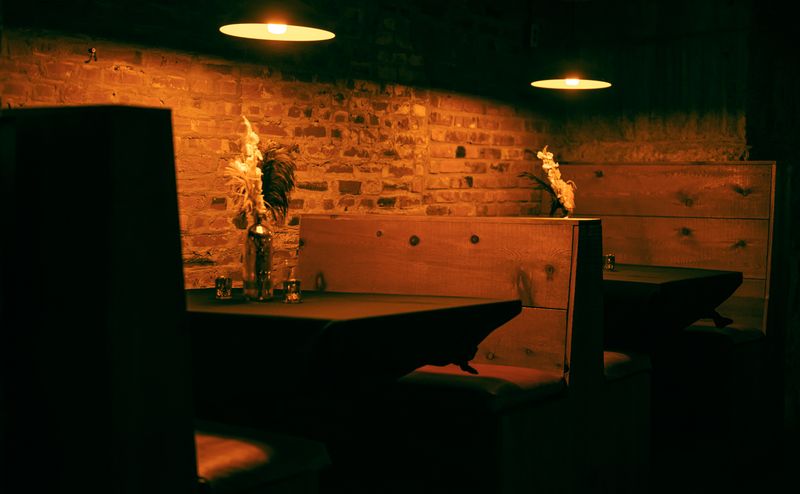 Warm-lit dining room with brick walls and pendant lamps — photo by Chris F on Pexels