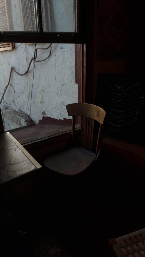 Free Photo of a Wooden Chair Near Window Stock Photo