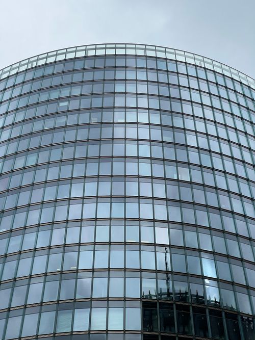 Free Curved glass facade of a modern building in Berlin, Germany. Stock Photo