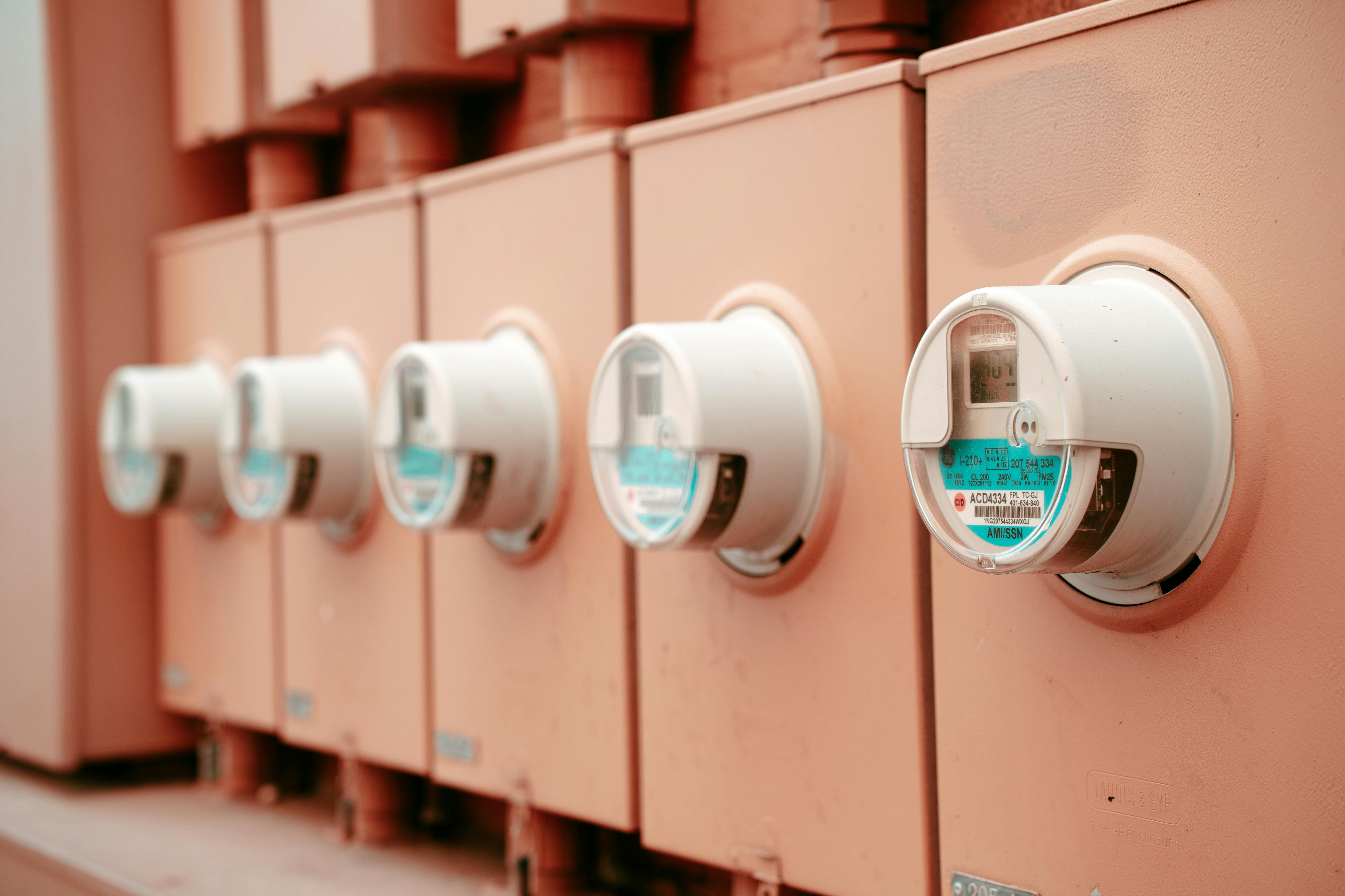 Close-up view of a row of industrial electricity meters for power monitoring and technology.