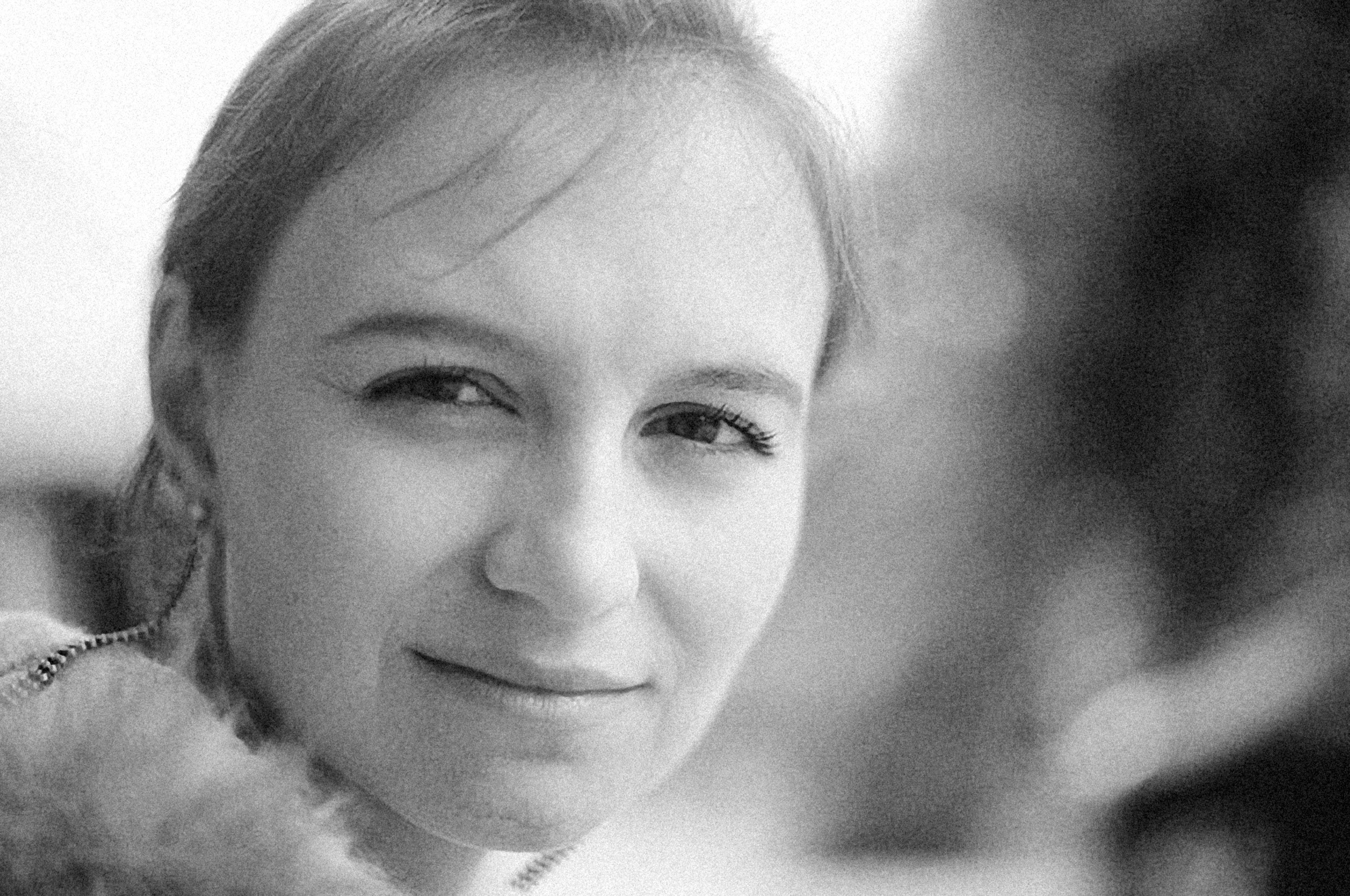Woman with a knowing half-smile, 90s style