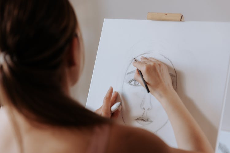 Woman Drawing Face With Pencil