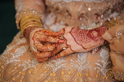 A Woman Hands with Henna Tattoos in Her Wedding