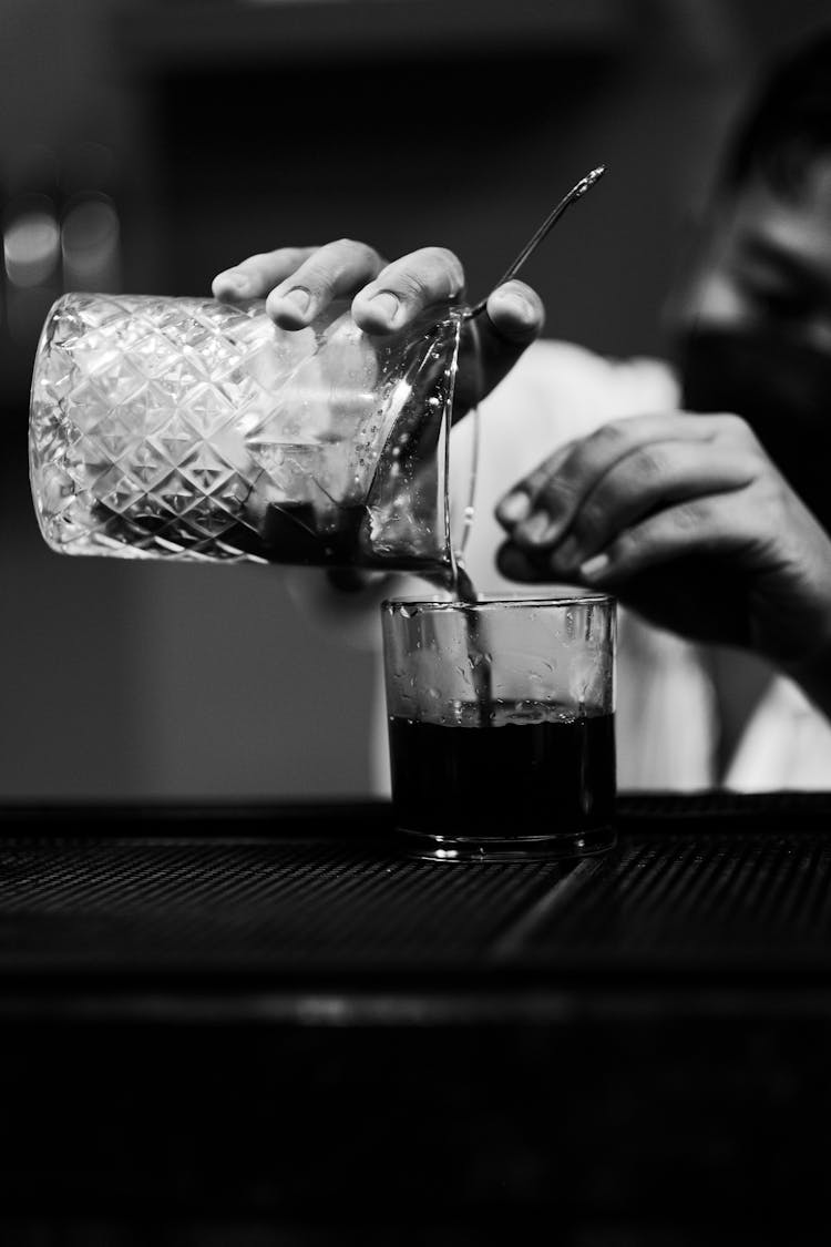 Black And White Photo Of Man Pouring Coffee