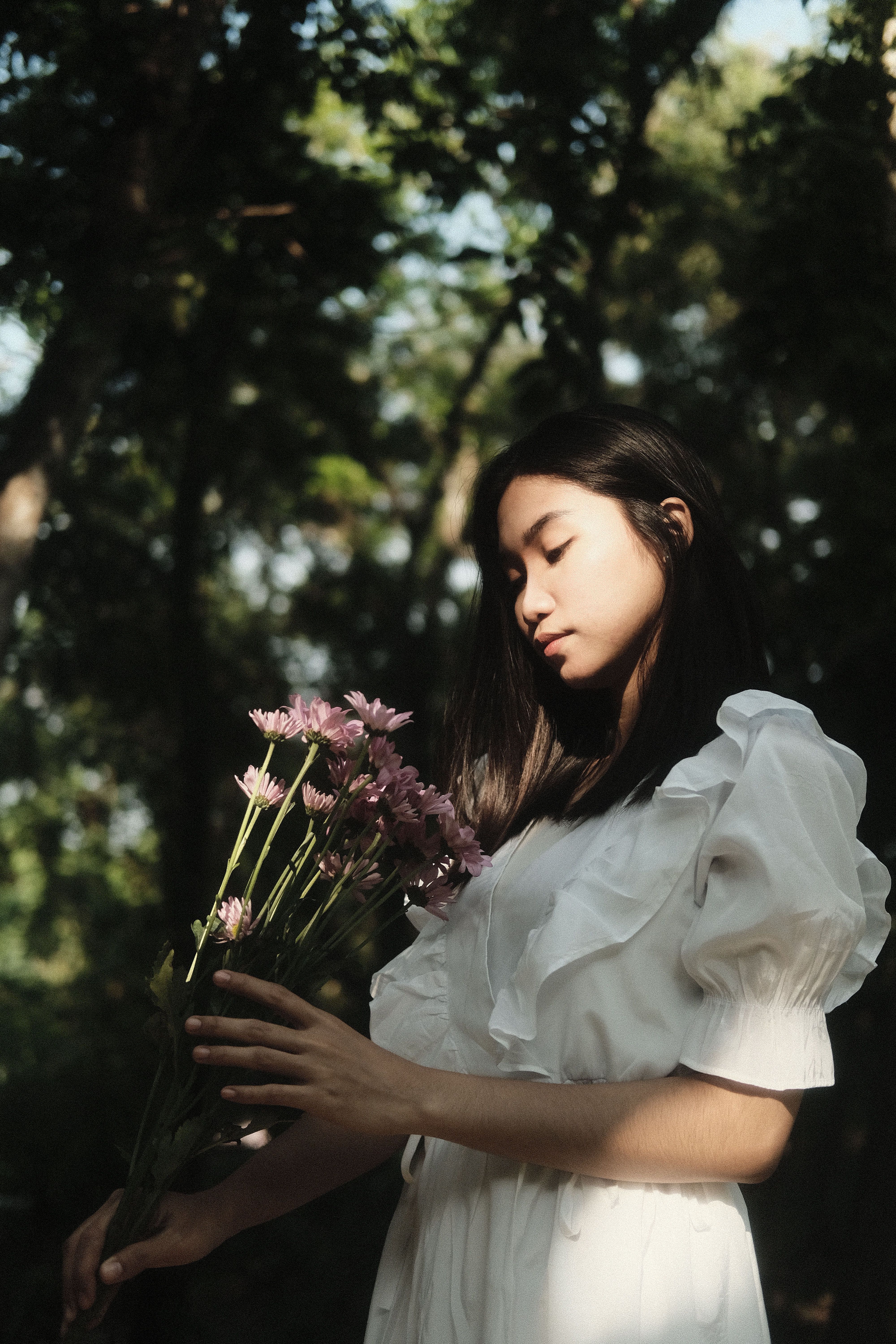 Woman in White Dress Holding Flowers · Free Stock Photo