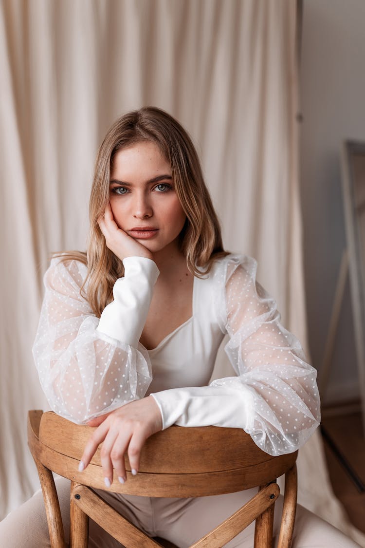 Woman Sitting On A Chair Backwards 