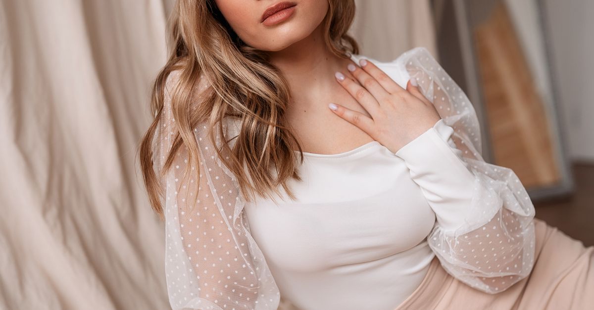 Woman wearing a sheer-sleeve blouse with a pencil skirt