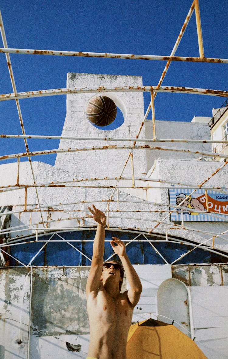 Shirtless Man Throwing A Ball