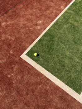 Close-up of a tennis ball on a mixed clay and grass court in Odesa, Ukraine.