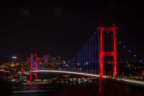 Free Night view of Istanbul's Bosphorus Bridge with vibrant lights highlighting the urban skyline. Stock Photo