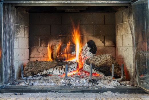 Cozy living room fireplace burning on a winter evening — fireplace winter checklist for homeowners
