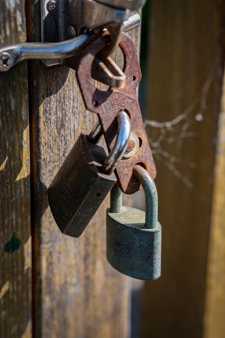 Close-up Of Locks On Wooden Door