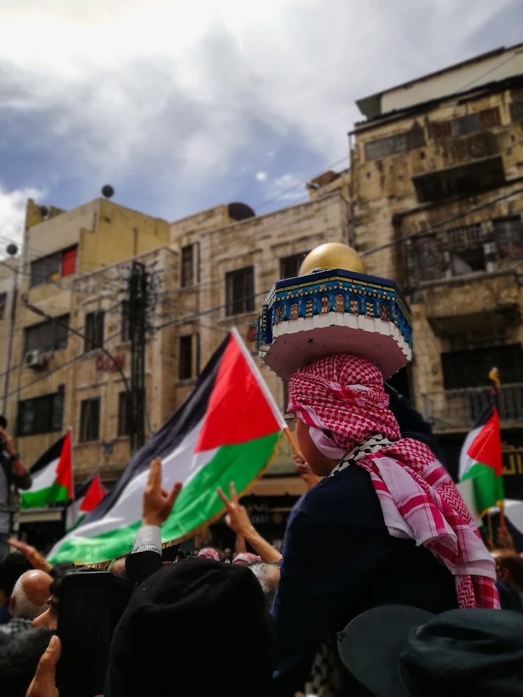 People Marching On Street Demonstration With Flags