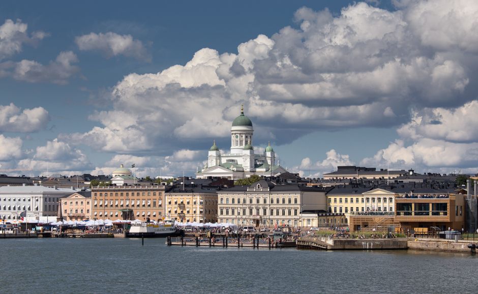 A stunning view of Helsinki's vibrant cityscape with the iconic Helsinki Cathedral under a dramatic sky.