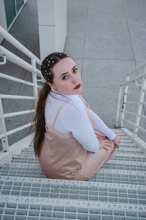 High-Angle Shot of a Beautiful Woman Sitting on Stairs