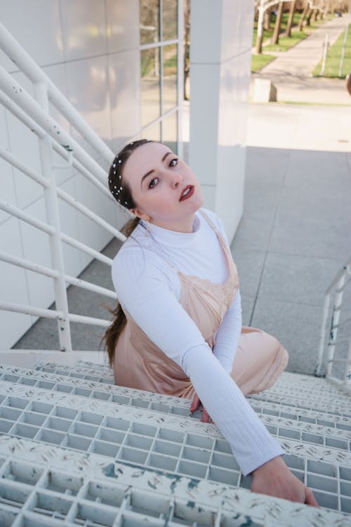 High-Angle Shot of a Beautiful Woman Sitting on Stairs