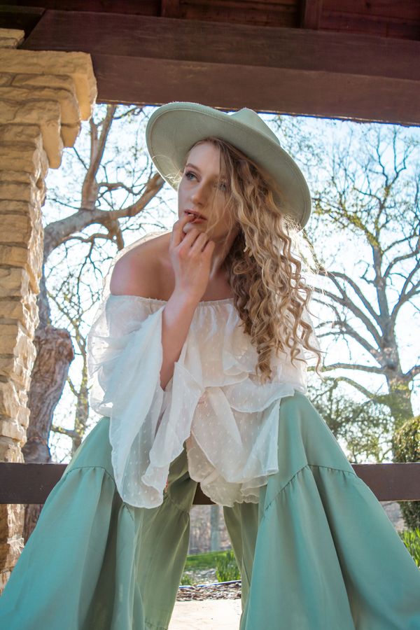 Woman in a sage green outfit and hat — Sarah Estes on Pexels