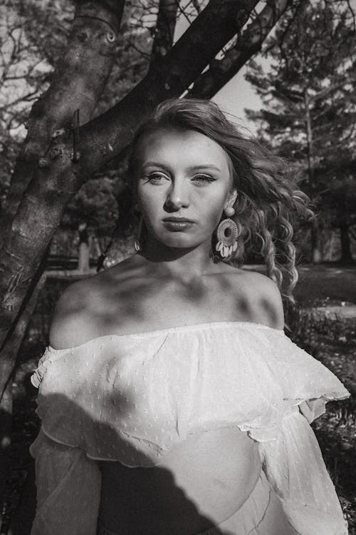 Grayscale Photo of a Woman in a White Off Shoulder Top