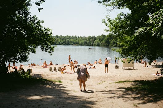People enjoying a sunny day on a beach in Kyiv, Ukraine by the Dnipro River.