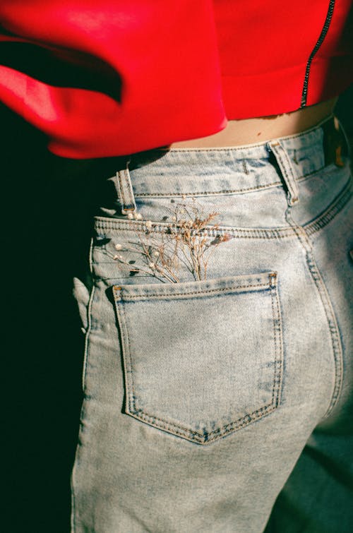 Free Person Wearing Denim Jeans with Flowers in the Pocket  Stock Photo