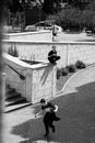 Grayscale Photo of 2 Children Playing on the Stairs