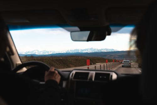 A Person Traveling a Road with a Car