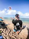 A Man Trying Kiteboarding in the Beach