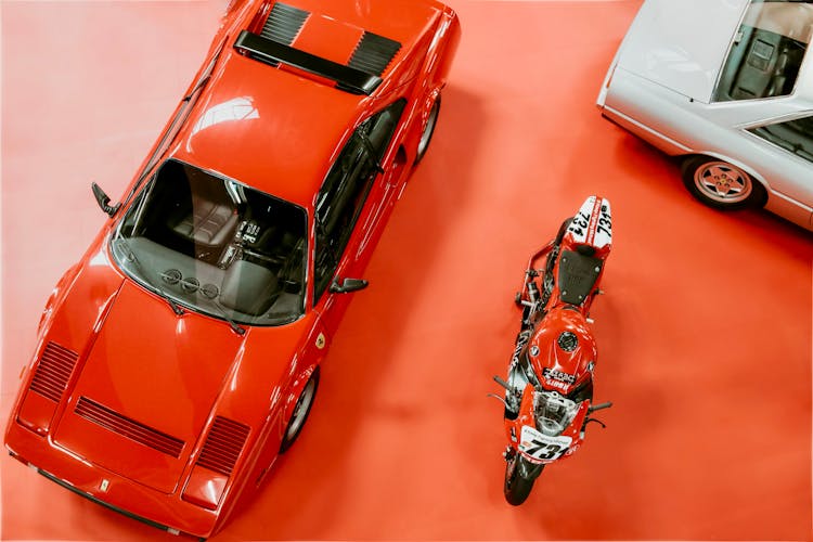 Vintage Sportscar And Motorcycle In A Show Room