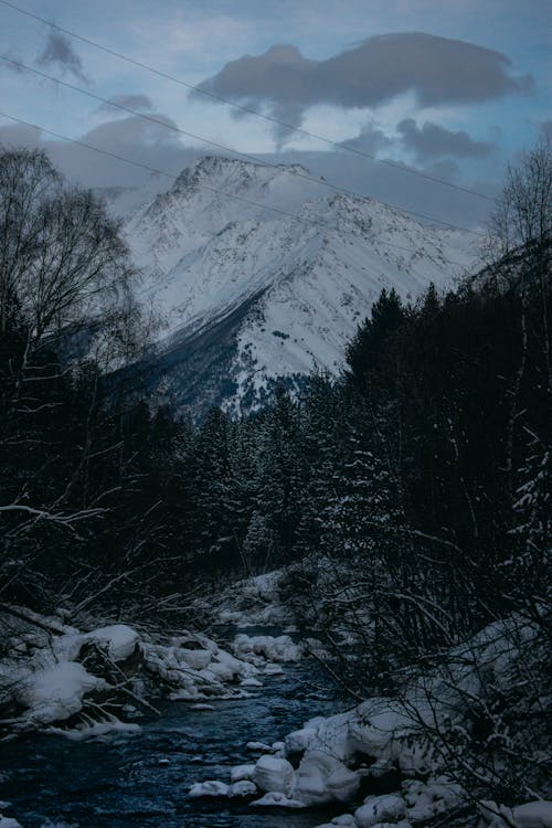Snowcapped Mountains and Stream in Winter 