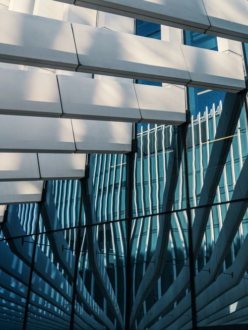 Free Artistic reflection of a modern building's geometric lines and windows, showcasing its contemporary design. Stock Photo