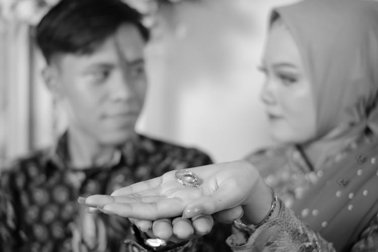 Wedding Rings On The Palm Of The Woman